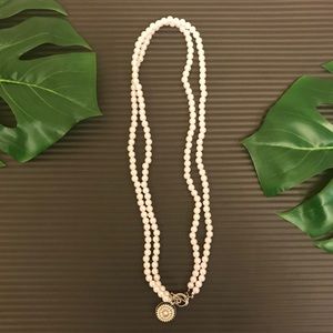 Long pearl snap necklace.